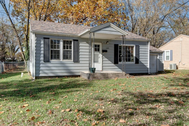 view of front of house with a front lawn and cooling unit