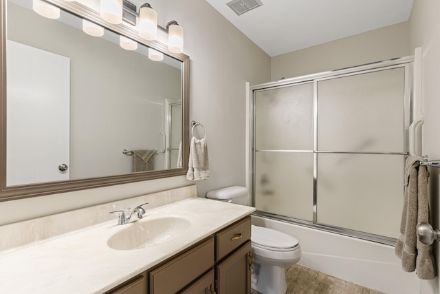 full bathroom featuring bath / shower combo with glass door, vanity, and toilet