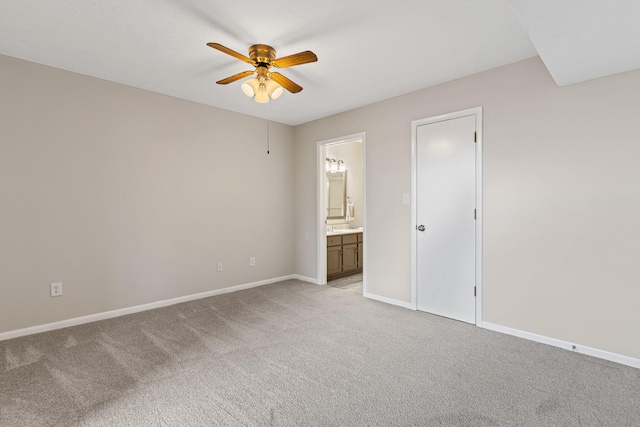 unfurnished bedroom featuring ensuite bathroom, ceiling fan, and light colored carpet