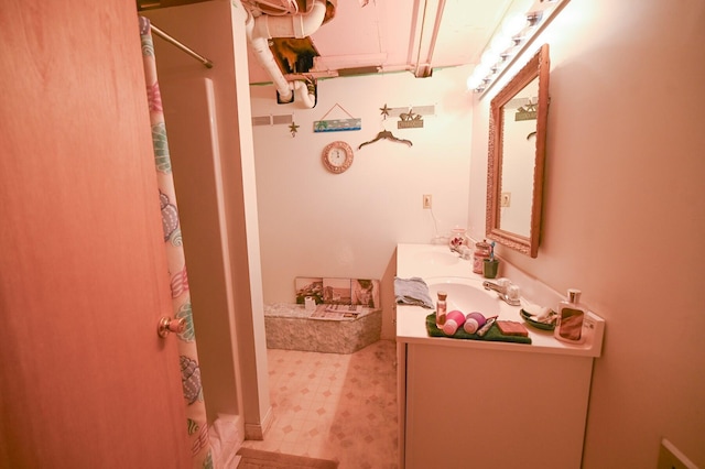 bathroom featuring vanity and curtained shower