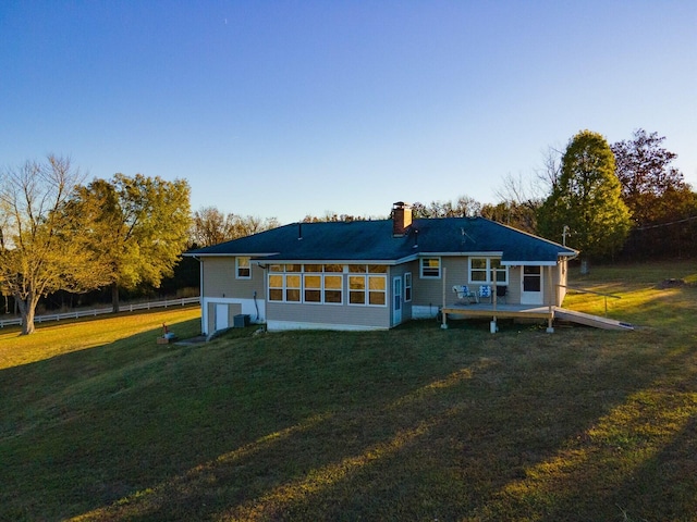 rear view of property featuring a yard