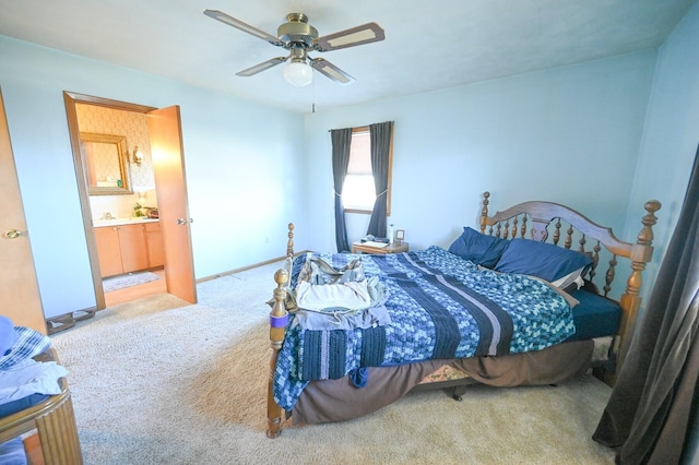 bedroom featuring carpet, ceiling fan, and ensuite bath