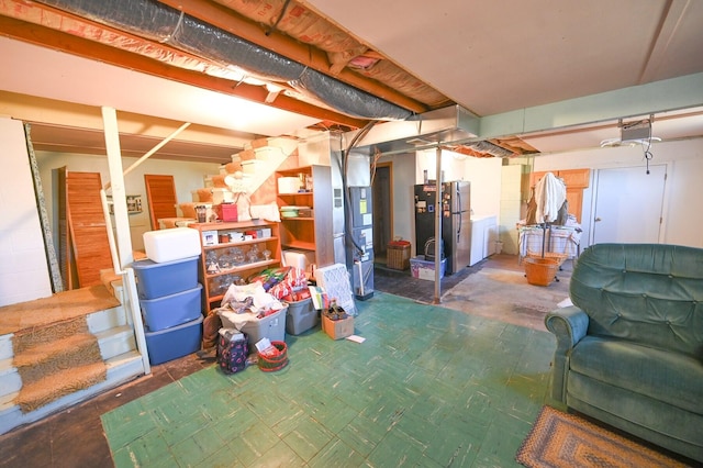 basement featuring stainless steel refrigerator