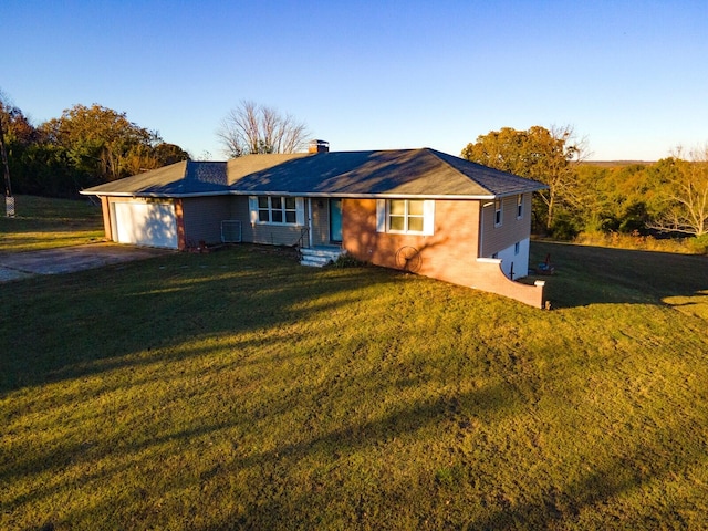 ranch-style home featuring a garage and a front yard