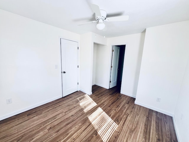 spare room featuring ceiling fan and dark hardwood / wood-style floors