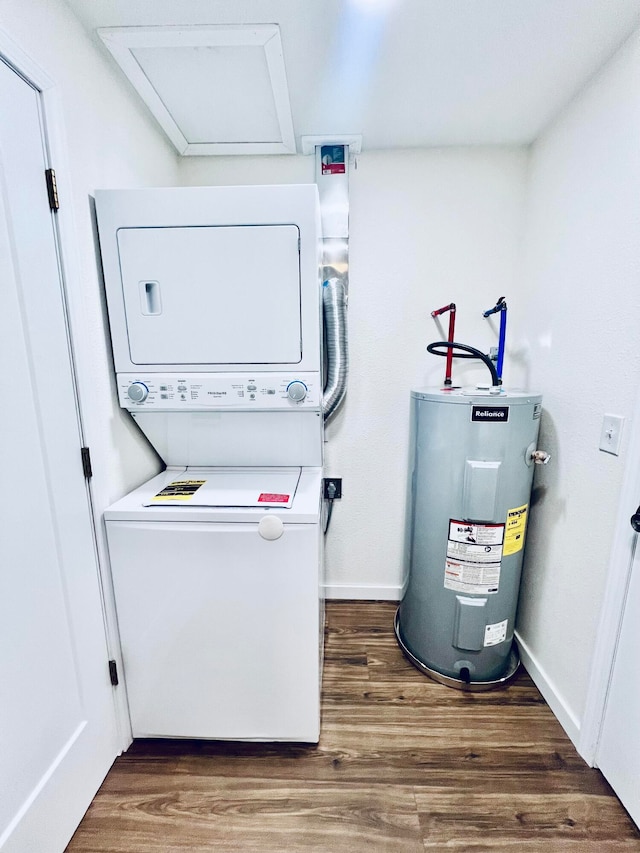 laundry room with electric water heater, stacked washer and dryer, and dark hardwood / wood-style floors