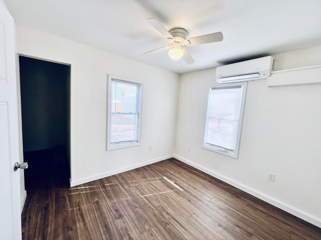 unfurnished room featuring ceiling fan, dark hardwood / wood-style floors, and an AC wall unit