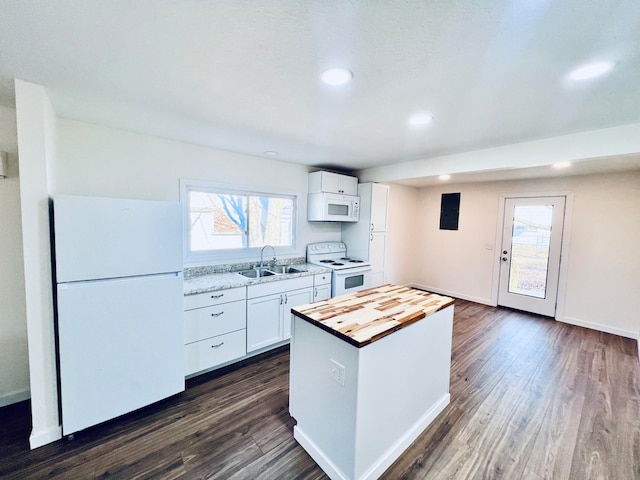 kitchen with white appliances, dark hardwood / wood-style floors, white cabinetry, and a healthy amount of sunlight