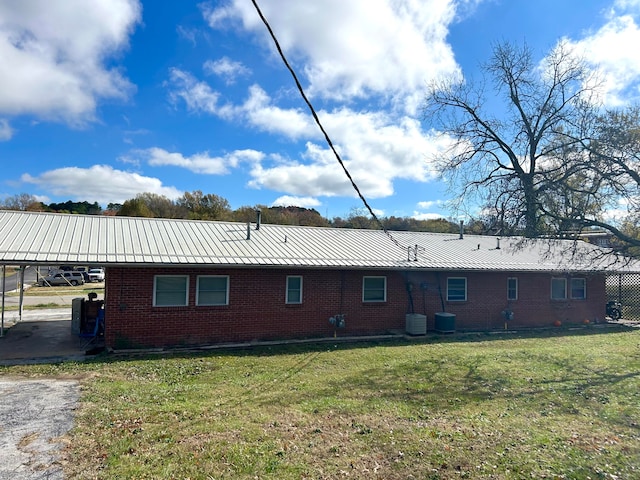 back of house featuring a yard and cooling unit