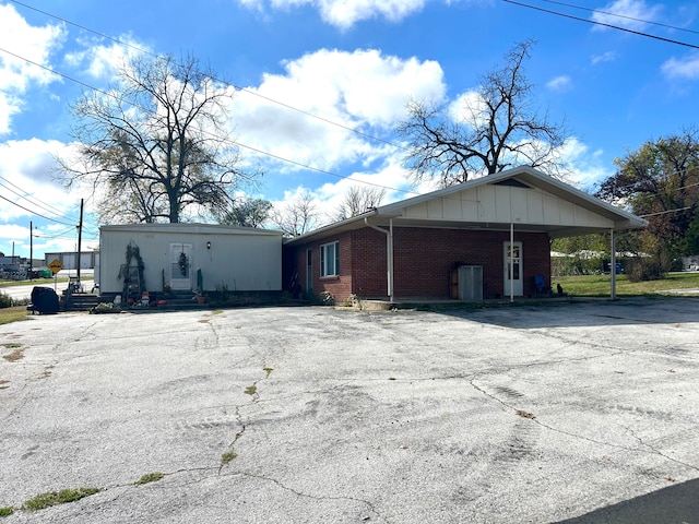 view of property exterior featuring a carport