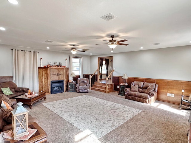 living room with ceiling fan and carpet floors