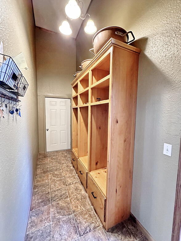 mudroom featuring lofted ceiling