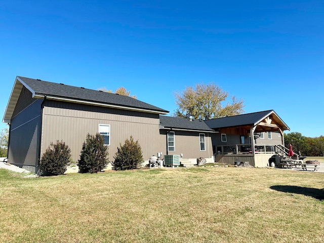 view of side of home featuring a yard and a wooden deck