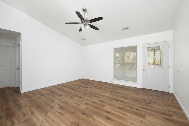 spare room featuring ceiling fan, a textured ceiling, vaulted ceiling, and dark hardwood / wood-style floors