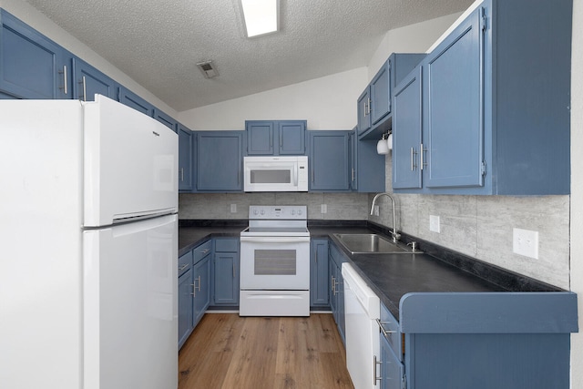 kitchen featuring sink, white appliances, lofted ceiling, blue cabinets, and light wood-type flooring