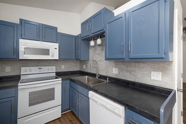 kitchen with white appliances, sink, and blue cabinets