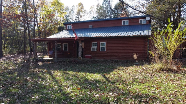 back of house with a lawn