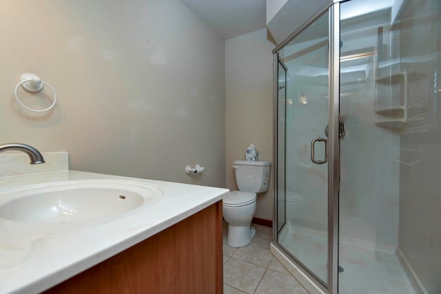 bathroom featuring vanity, a shower with shower door, tile patterned floors, and toilet