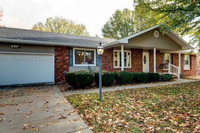 ranch-style home with a garage and covered porch