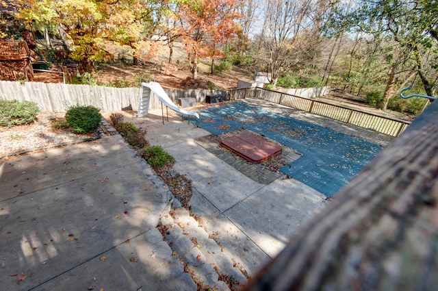 view of swimming pool featuring a patio and a water slide