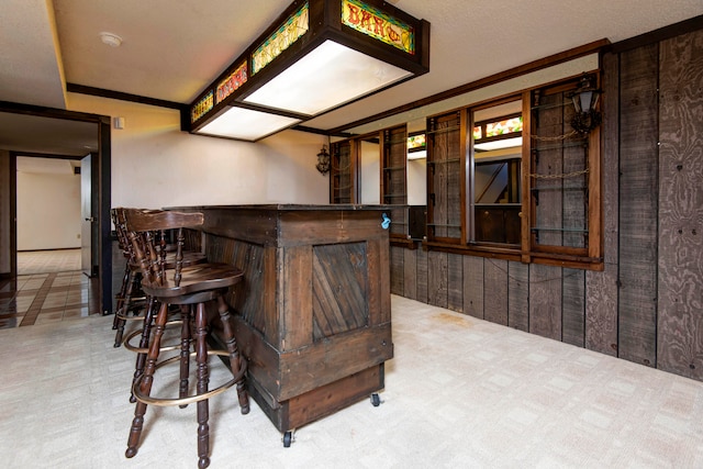 bar featuring carpet flooring and ornamental molding