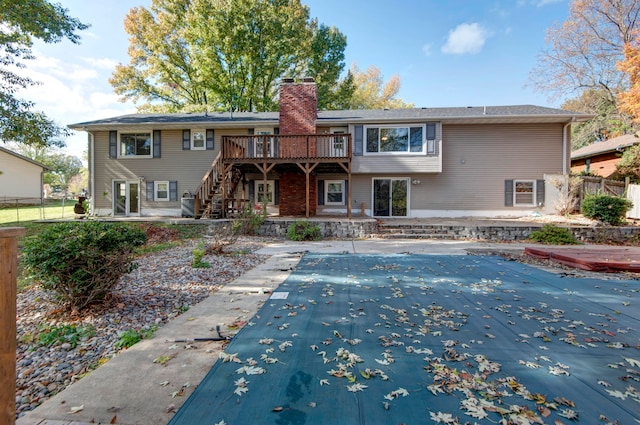 rear view of house with a patio and a pool side deck