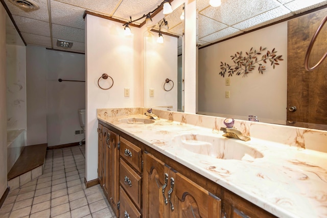 bathroom with vanity, tile patterned floors, toilet, and a shower