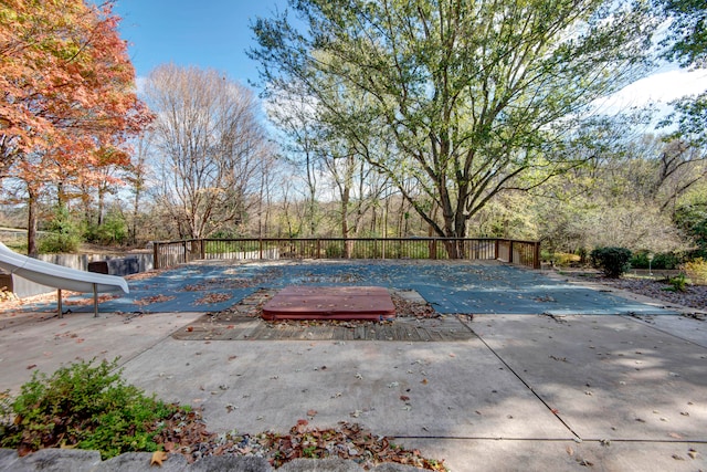 view of pool featuring a deck and a patio area