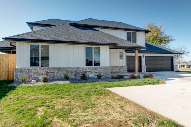 view of front of property featuring a garage and a front yard