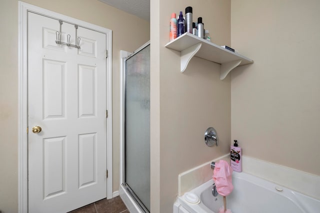 bathroom with tile patterned flooring, a textured ceiling, and separate shower and tub