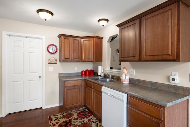 kitchen with dark wood-type flooring, sink, and white dishwasher