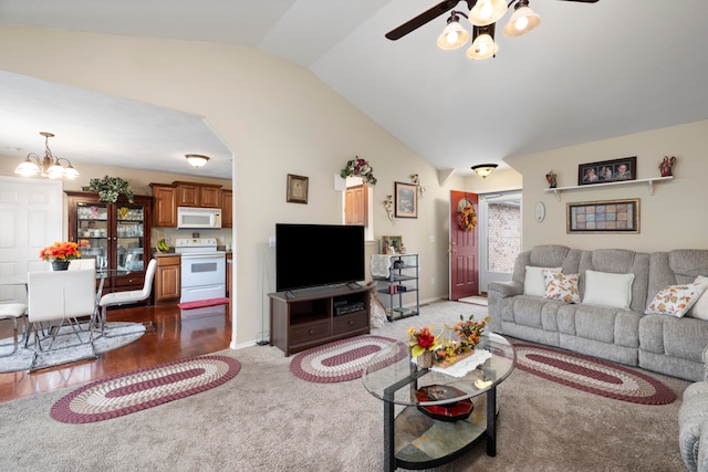 living room featuring hardwood / wood-style flooring, ceiling fan with notable chandelier, and lofted ceiling