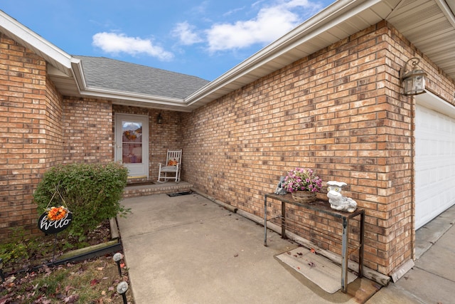 view of exterior entry with a garage