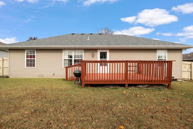 back of property with a lawn and a deck