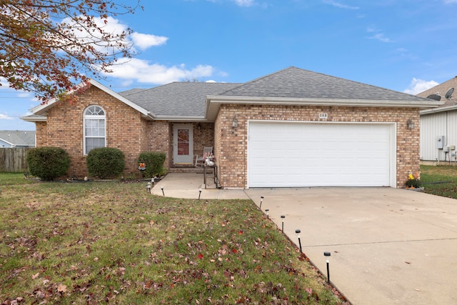 single story home featuring a garage and a front lawn