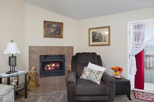 living area featuring carpet and vaulted ceiling