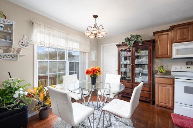 dining area featuring dark hardwood / wood-style flooring and a notable chandelier