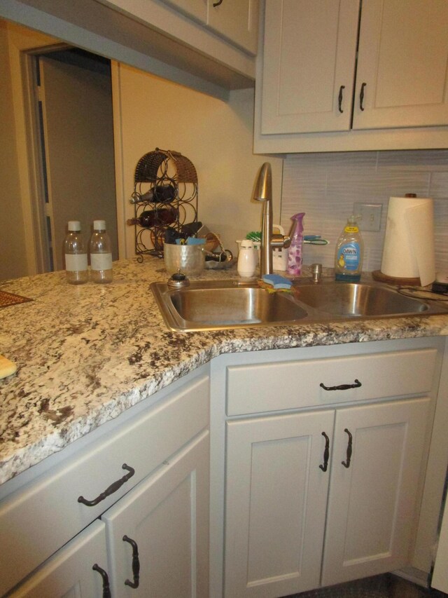 27038 Hickory Dr, Eagle Rock, MO 65641 - kitchen featuring a sink, backsplash, white cabinets, and light stone countertops