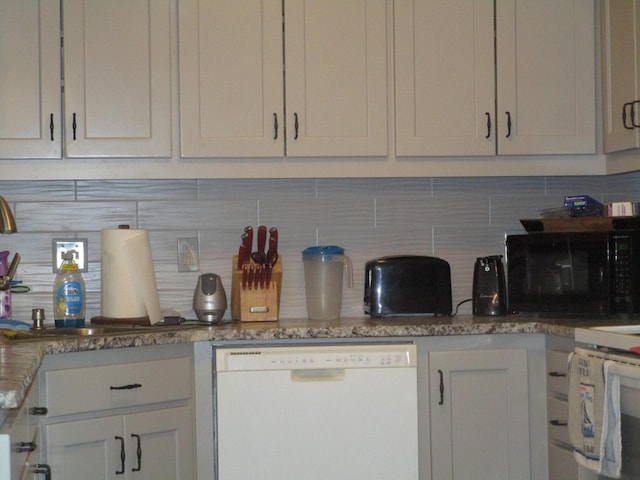 27038 Hickory Dr, Eagle Rock, MO 65641 - kitchen featuring dishwasher, black microwave, tasteful backsplash, and light stone counters