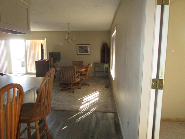 27038 Hickory Dr, Eagle Rock, MO 65641 - carpeted dining room featuring plenty of natural light, a chandelier, and baseboards