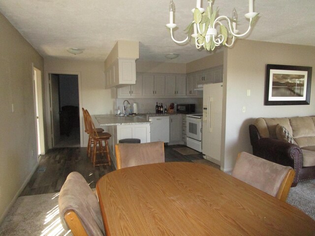 27038 Hickory Dr, Eagle Rock, MO 65641 - dining space featuring a chandelier and baseboards