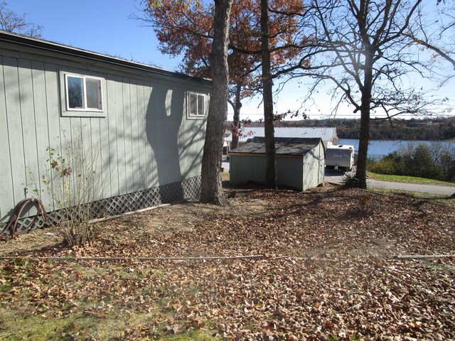 27038 Hickory Dr, Eagle Rock, MO 65641 - view of property exterior featuring a water view and an outdoor structure
