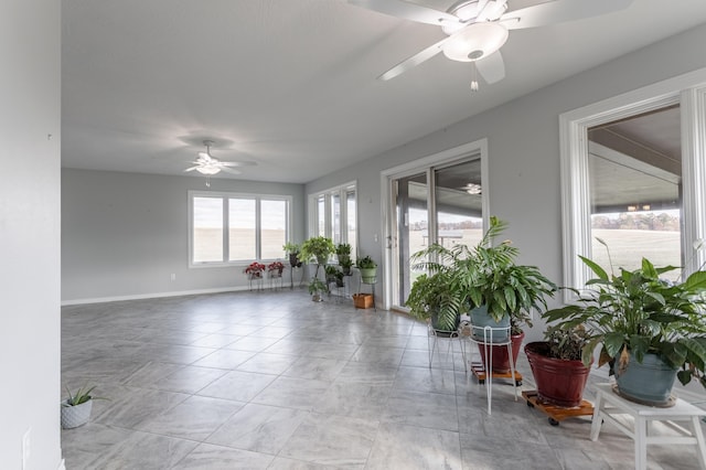 interior space featuring a healthy amount of sunlight and ceiling fan
