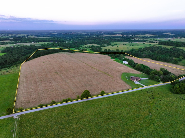 aerial view at dusk featuring a rural view