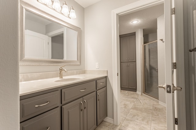 bathroom with vanity and a shower with shower door