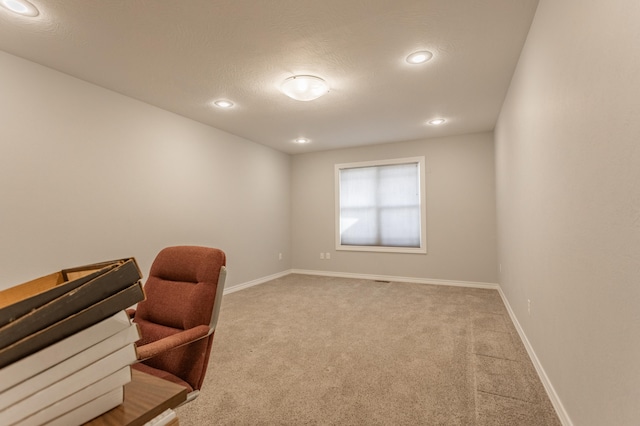 carpeted office featuring a textured ceiling