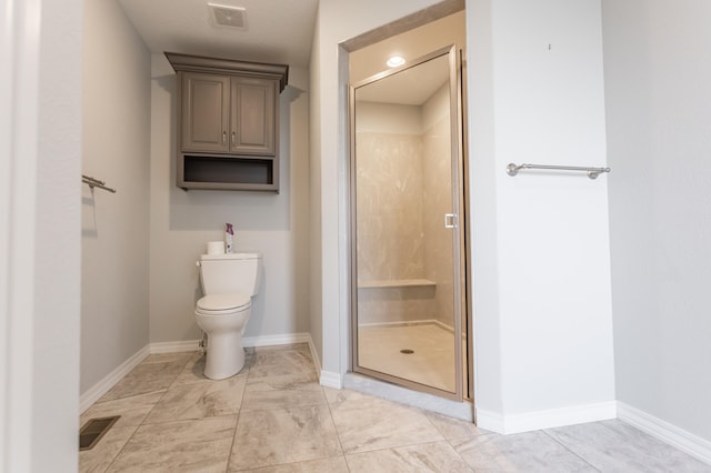 bathroom featuring toilet and an enclosed shower