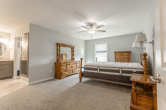 carpeted bedroom featuring ceiling fan and ensuite bath