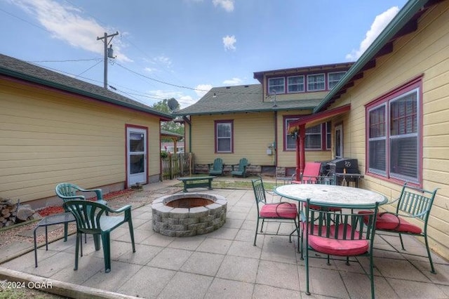 view of patio with area for grilling and an outdoor fire pit