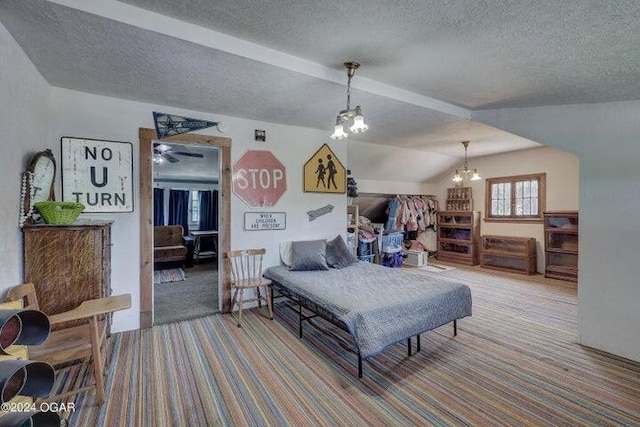 carpeted bedroom with a textured ceiling, vaulted ceiling, and an inviting chandelier